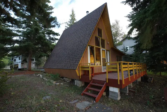 A-frame cabin among the spruce trees